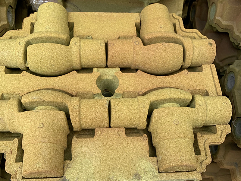 Jak rozwiązać wadę przyklejania piasku w produkcji szarych części żeliwa za pomocą technologii piasku powlekanego filmowego?